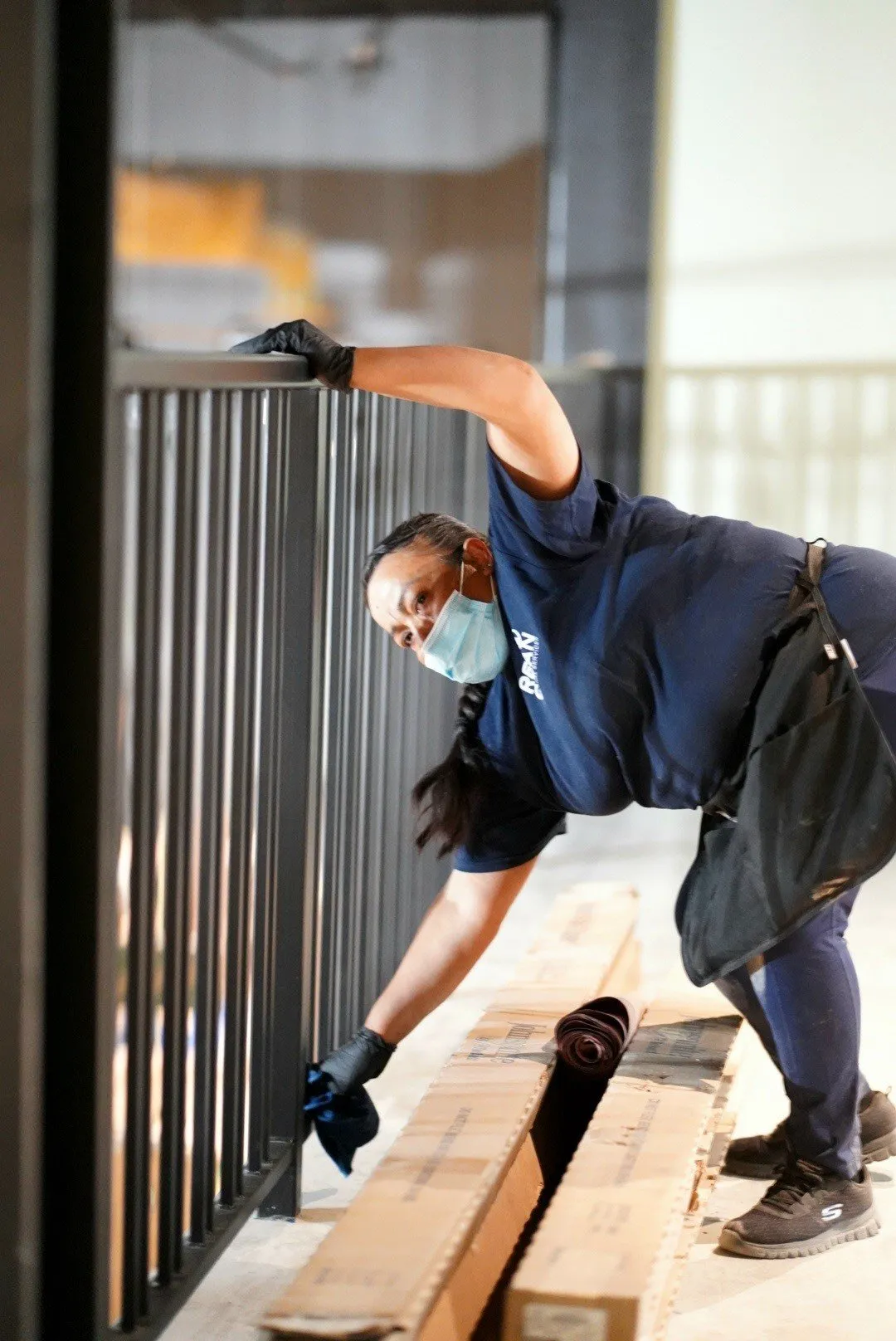 Final clean phase: janitor detailing a railing